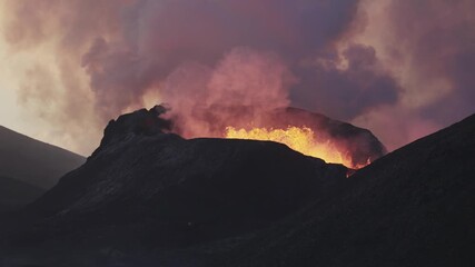 Dramatic silhouette of volcanic crater erupting at night. Massive smoke plume and glowing orange magma against dark sky. - Powered by Adobe