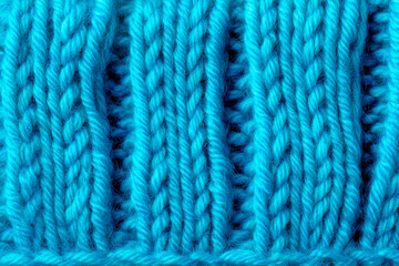 Fototapeta premium Vibrant blue knitted fabric macro with detailed wool fibers and braided yarn texture. High-resolution textile background perfect for design, branding, packaging, and creative projects.