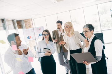 Diverse professional team brainstorming in office meeting, discussing strategies in a collaborative environment