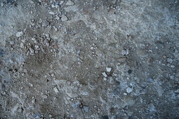 Close-up of a gray-black lava texture on the ground. Porous, cracked, and stony, perfect as a stock texture or photo background. Impression of molten rock.