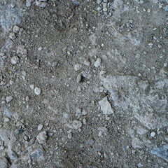 Close-up of a gray-black lava texture on the ground. Porous, cracked, and stony, perfect as a stock texture or photo background. Impression of molten rock.