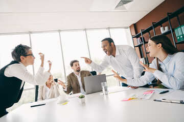 Intense workplace disagreement during a business meeting with diverse colleagues debating ideas in an office setting