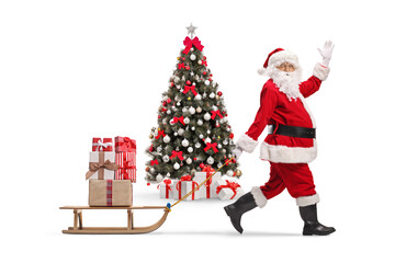Decorated Christmas tree and Santa claus with presents on a sled