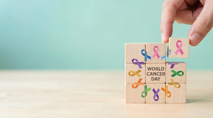 Wooden blocks featuring multicolored awareness ribbons for the various diseases being assembled to highlight world cancer day.