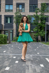 Naklejka premium Lady with puppy dog. Young beautiful woman walks with her poodle dog