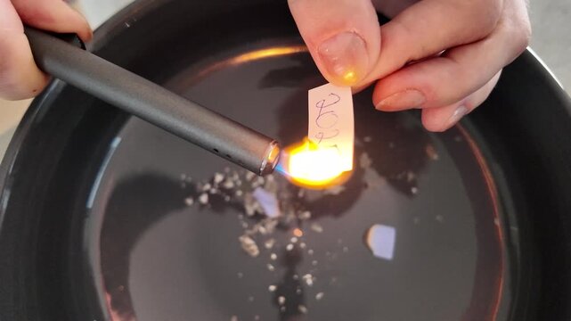 Casual experimenter demonstrates safe paper ignition creating smoke and embers