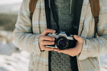 Person holding vintage film camera outdoors