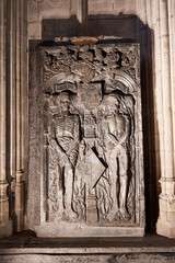 Stone funerary monument of Claude Bouton and his wife, located inside Notre-Dame du Sablon Church in Brussels, Belgium. The detailed sculpture features skeletal figures in a dramatic memento mori 