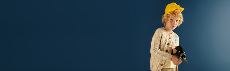 Curious boy with wavy blonde hair posing playfully in a studio setting