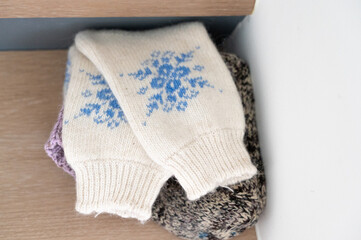 Warm textile display, Serene presentation of winter wear with intricate floral embroidery and textured layering