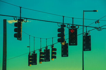 Several traffic lights hanging over the wires
