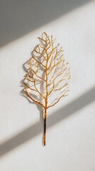 Golden Leaf Art on White Wall with Shadows art minimalism golden leaf art wall shadows