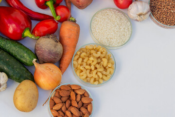 Set of basic healthy eating ingredients: vegetables, grains, and nuts with copy space