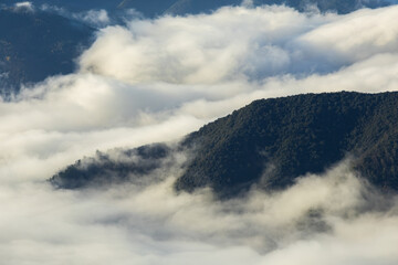 Mountain peaks rising above morning clouds in Garrotxa