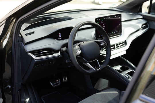 Interior of prestige modern electric car. Leather comfortable seats, dashboard and steering wheel. Cockpit with exclusive decoration. Modern electric car interior luxury - Powered by Adobe