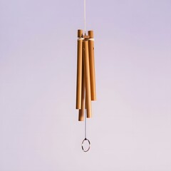 Golden chimes hanging against a softly lit background