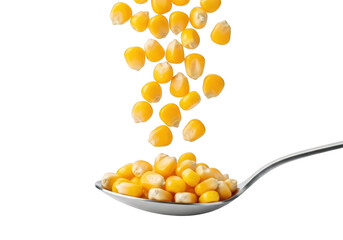 Dried corn kernels pouring into a metal spoon, close-up shot. raw ingredient. isolated on transparent background