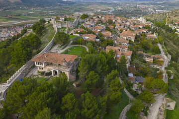 Aerial view of Berat Castle revealing stone walls, hilltop homes and sweeping landscapes across the Osum River valley.
