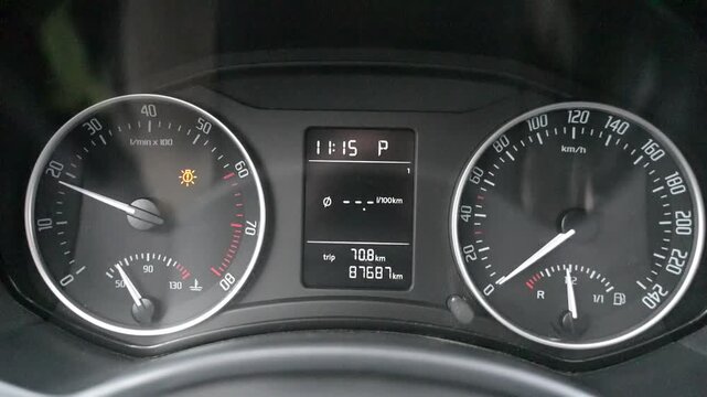 A close-up of a car speedometer. Detailed readings, a smooth needle movement, instrument panel illumination, and a modern automotive design.