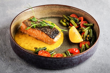 Gourmet salmon fillet accented by citrus and crispy accompaniments
