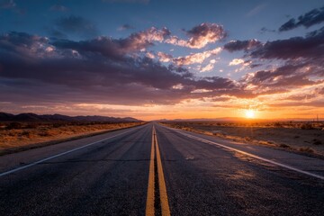 Naklejka premium Desert road stretching into warmth under vibrant sunset sky with distant mountains, surrounded by sparse shrubs, evoking tranquility and solitude in a stunning natural landscape