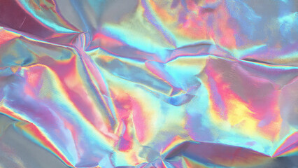 A vibrant, crinkled holographic foil surface shimmering with an iridescent spectrum of pink, blue, purple, and yellow light, creating an abstract, futuristic texture.