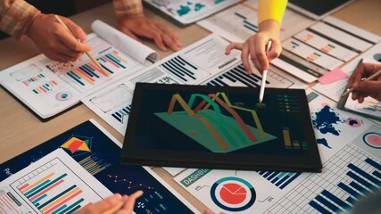 This image captures a team in a modern office engaged in a business meeting, analyzing data on a dashboard with charts and graphs to drive informed decisions. SACTR - Powered by Adobe