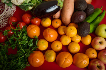 Vibrant Fresh Produce Display With Fruits, Vegetables, And Greens On Red Table
