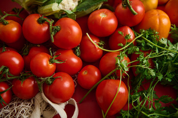 Fresh Tomatoes and Parsley Bunch on Red Surface, Colorful Market Produce Display