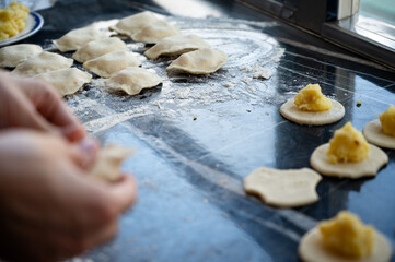 Making homemade dumplings with potato filling