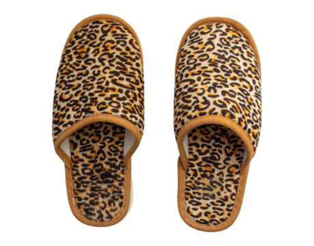 Leopard print fuzzy slippers with brown trim isolated on a white background
