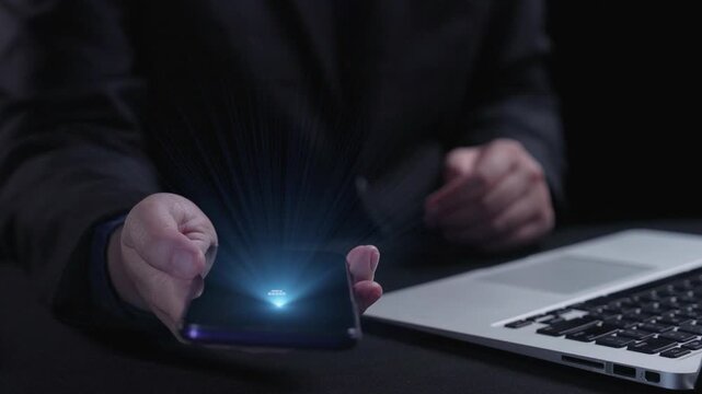 A professional setting featuring a smartphone and laptop with a display of contact icons, representing modern digital communication methods and customer engagement. Qubit