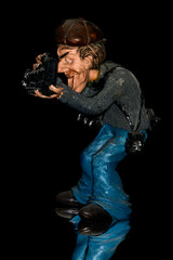 Ceramic figure of an old photographer with photo equipment.