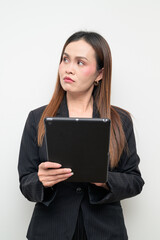 Naklejka premium Asian Business Woman Studio Portrait on White Background Using Digital Tablet Computer Thinking