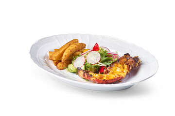 Grilled lobster tail, golden potato wedges, and crisp fresh salad on a white plate