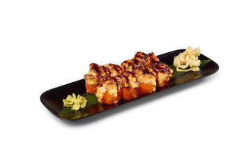 Baked sushi rolls serving on black plate with wasabi and pickled ginger