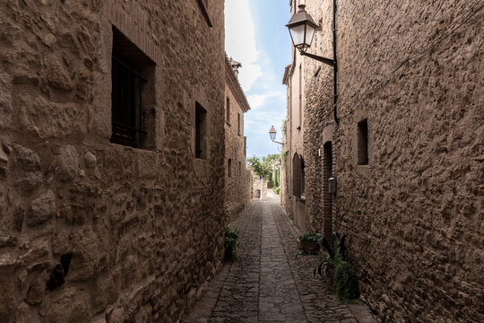 Peratallada medieval alleyway with traditional stone buildings