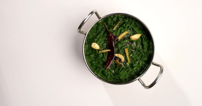Makki Ki Roti & Sarson Ka Sag is basically Corn floor flat bread & curry using mustard greens respectively. Popular Punjabi food. Served in a bowl and plate over moody background. selective focus