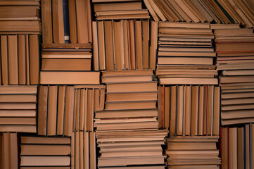 Stacked vintage books forming textured wall pattern