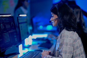 Data analyst deep dive night shift analyzing complex metrics visualizations dashboard screen headset facilitates remote team collaboration insights extraction critical business intelligence achieved.