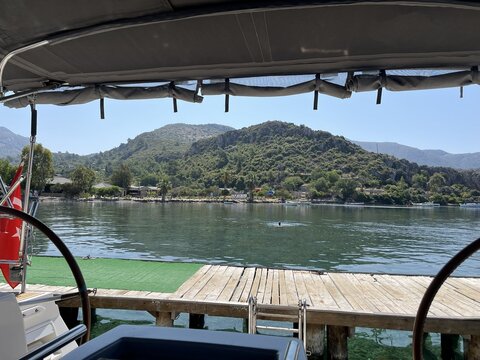 Sea view with mountains from a shaded boat on a sunny day