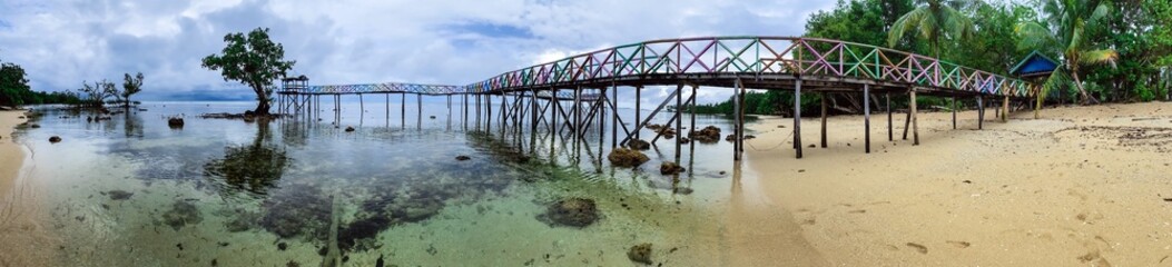 Panoramic View of Wooden Pier on Secluded Tropical Beach. Scenic landscape panorama capturing the beauty of a hidden paradise and remote travel destination.