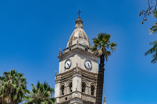 Cochabamba cathedral clock tower and palm trees