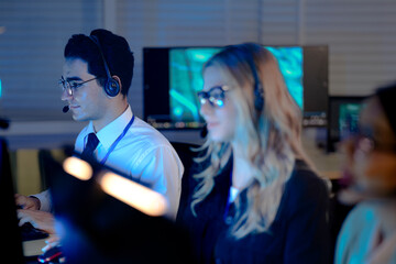 Command center lead focused intense monitoring critical systems late night headset connects team analyzing real time data screen crucial vigilance protects infrastructure operation underway now execut