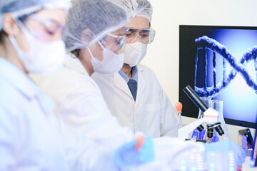 Diverse team of scientists in protective gear collaborating in modern blue lab, analyzing DNA helix...