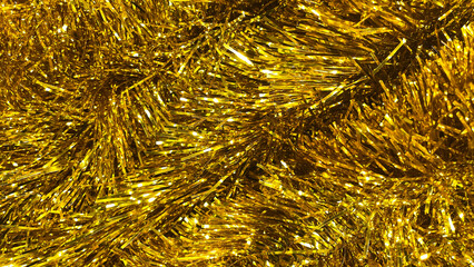 Golden tinsel Christmas tree bokeh background. Festive pattern. Xmas holiday spirit.