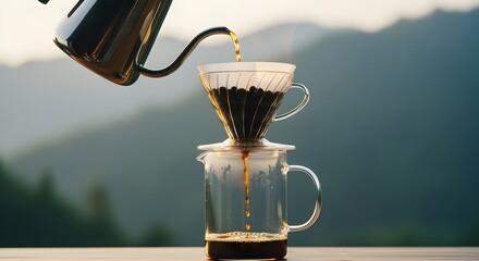 Morning ritual of brewing fresh pour-over coffee with a scenic mountain landscape view