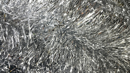 Silver tinsel Christmas tree bokeh background. Festive pattern. Xmas holiday abstract background.