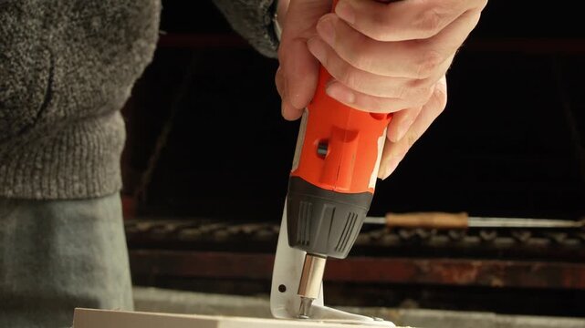 Fastening Material with Electric Screwdriver in Low Light