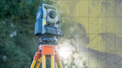 A surveying instrument is standing in front of a map. The map is filled with lines and dots, and the instrument is positioned in the foreground. Scene is one of precision and accuracy